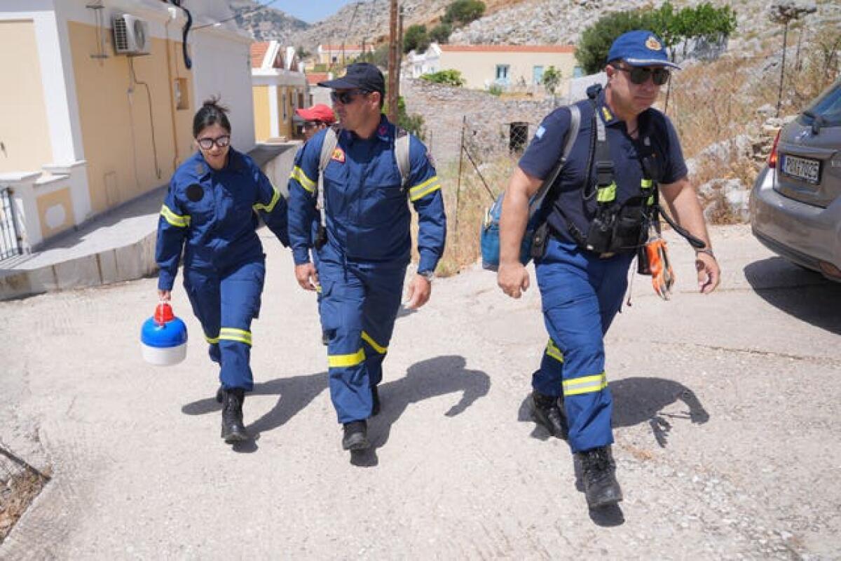 Firefighters join the search team in Pedi, a small fishing village in Symi, Greece, where a search and rescue operation is under way for TV doctor and columnist Michael Mosley