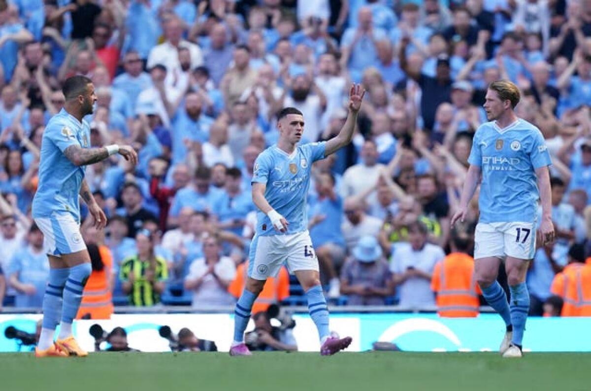 Phil Foden, centre, scored twice on the final day against West Ham 