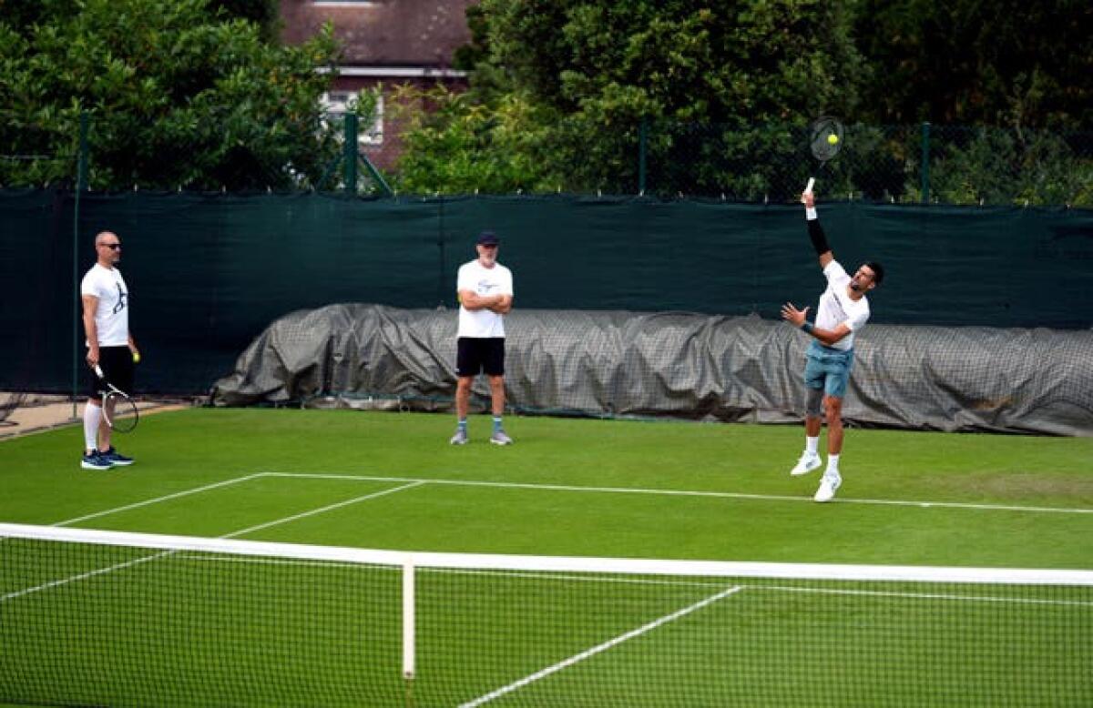 Novak Djokovic practises his serve