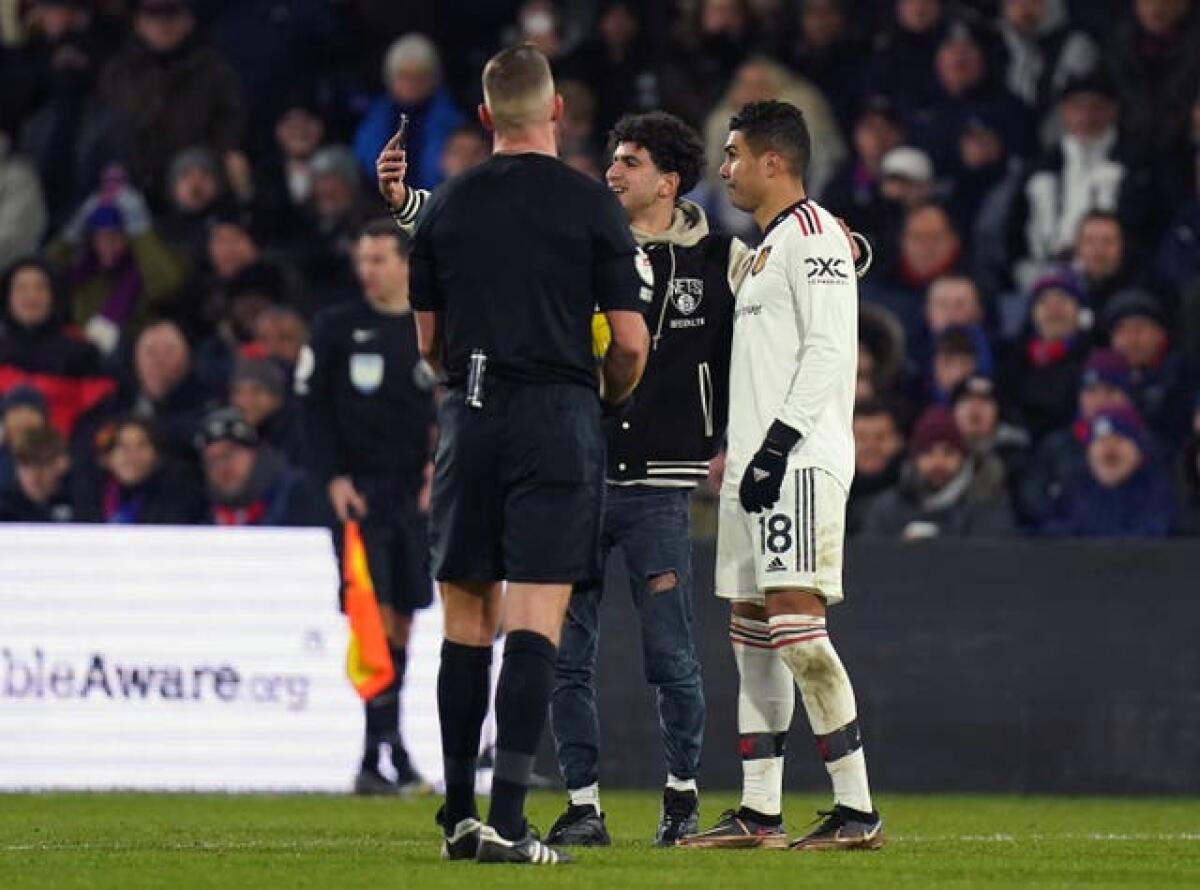 Casemiro has a selfie with a pitch invader at Selhurst Park