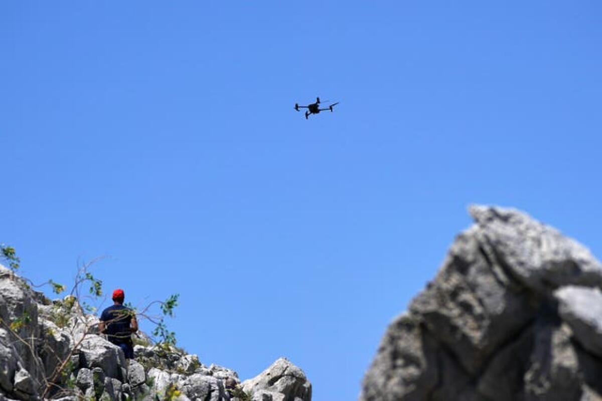 A member of the search team flying a drone in Symi, Greece, where a search and rescue operation is under way for TV doctor and columnist Michael Mosley