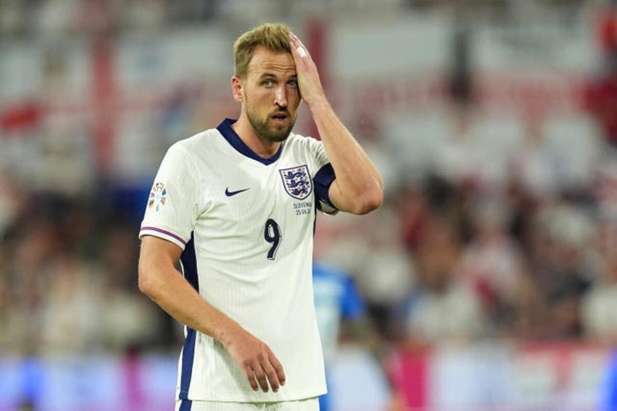 Harry Kane wipes sweat off his forehead during England's game with Slovenia 