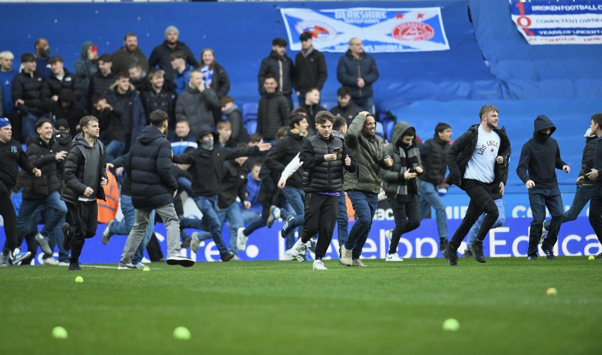 Reading fans ran on to the pitch in the 16th minute