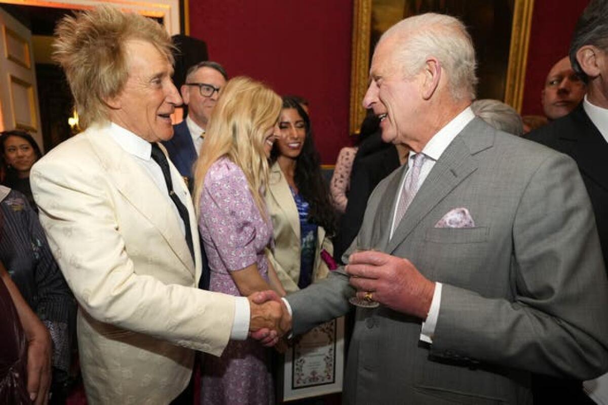 The King shaking hands with Sir Rod Stewart