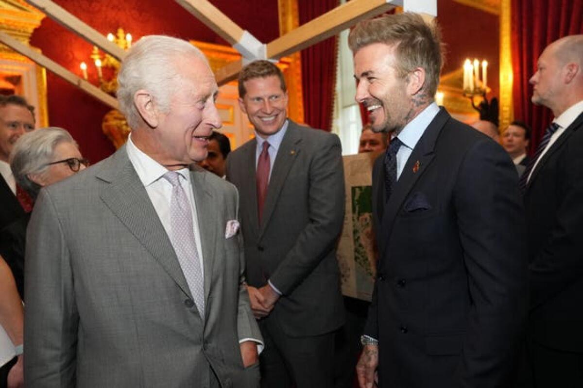The King smiled as he spoke to David Beckham