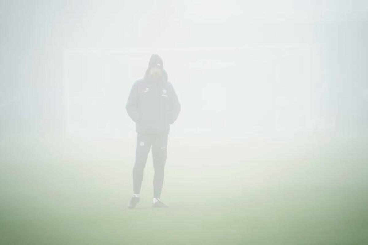 Graham Potter stands in the fog at Chelsea's Cobham Training Centre