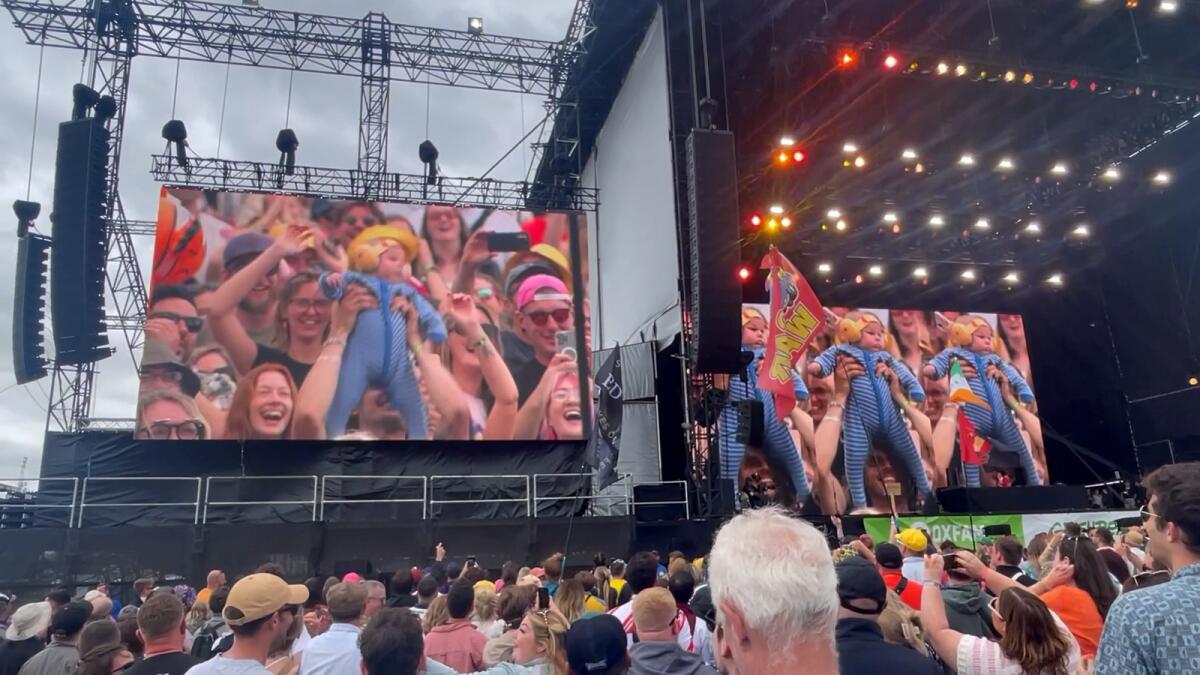 A baby boy is shown on the big screen at Glastonbury
