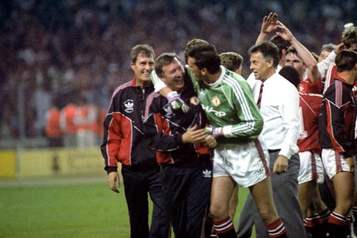 Sir Alex Ferguson celebrates with goalkeeper Les Sealey after winning the FA Cup