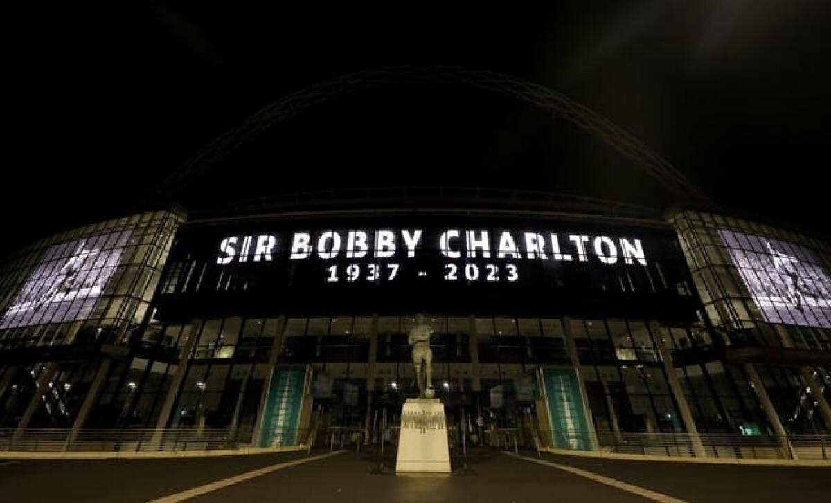 A tribute to Sir Bobby Charlton is displayed on giant screens outside Wembley Stadium 