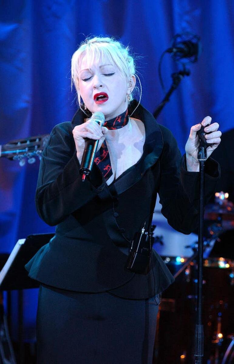 Cyndi Lauper performing in an all-black outfit