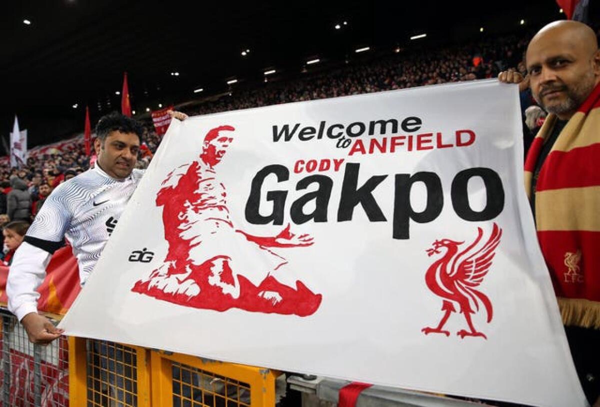 Liverpool fans hold up a banner welcoming the signing of Cody Gakpo