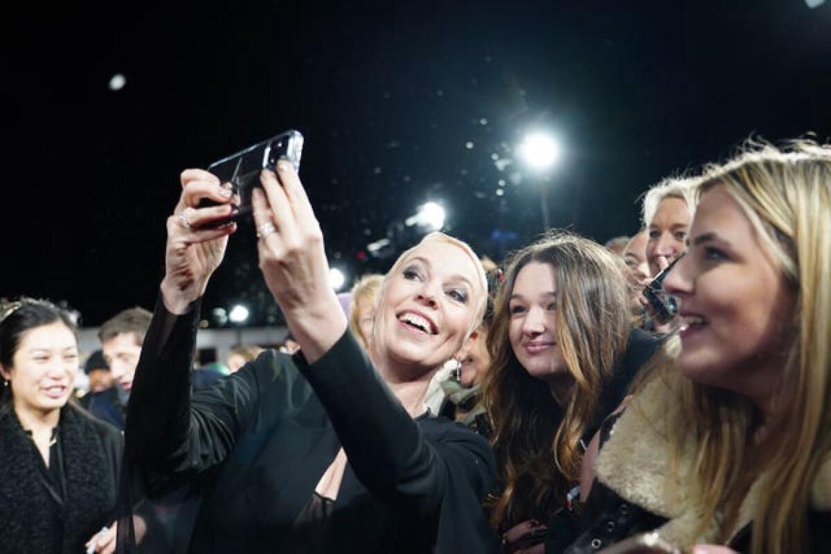Olivia Colman takes selfies with fans