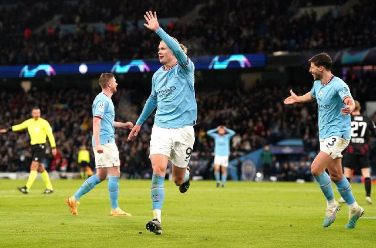 Erling Haaland celebrates his fifth goal against Leipzig as Kevin De Bruyne, left, and Ruben Dias, right, look on in astonishment