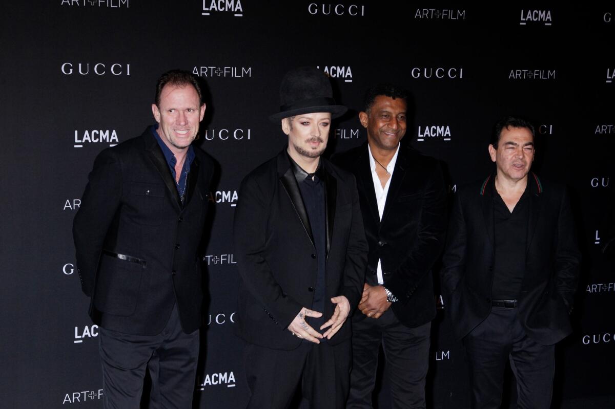 Boy George and his group Culture Club with members Mikey Craig, Roy Hay and Jon Moss in 2014 