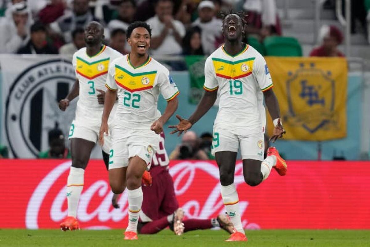 Senegal's Famara Diedhiou (right) celebrates scoring against Qatar
