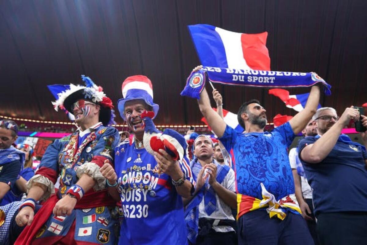 France fans wave flags and scarves before the FIFA World Cup Semi-Final match at the Al Bayt Stadium in Al Khor, Qatar 